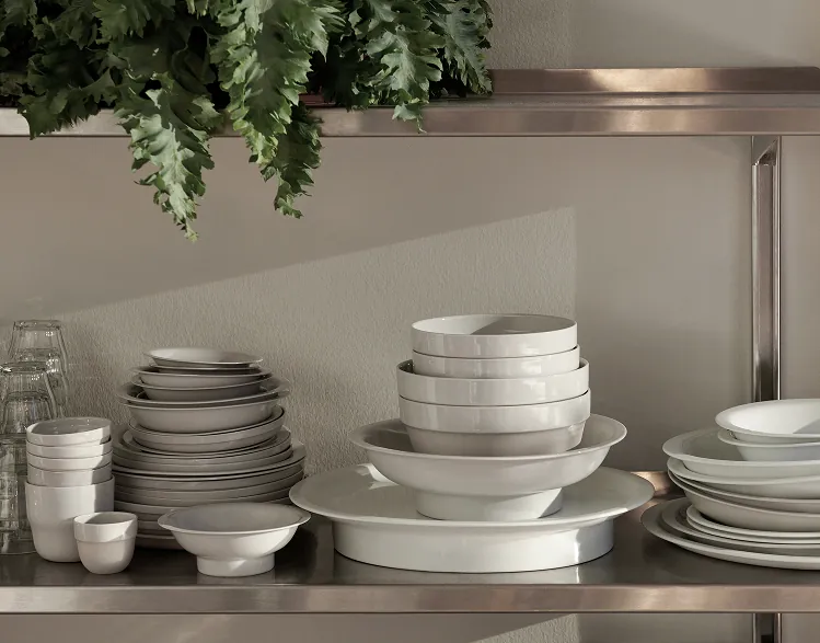 Shelves displaying porcelain plates, bowls and serving dishes