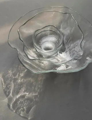 Clear glassware displayed on a dark surface