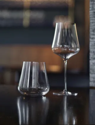 Stemmed wine glasses arranged on a bar